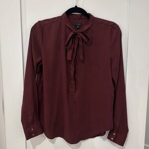 Ann Taylor maroon blouse in small with tie and button closures